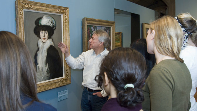 Students with lecturer viewing J D Fergusson - Hat With Bird: Anne Estelle Rice
