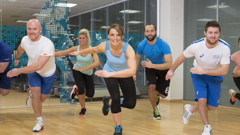 a group of men and women take part in a Glasgow Club class