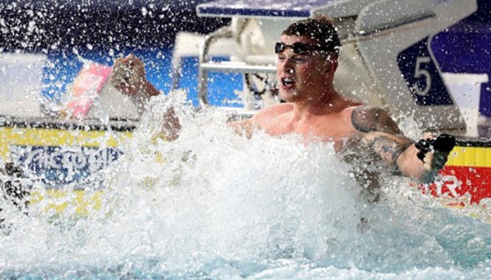 British swimmer Adam Peaty splashing the water in the pool at Tollcross International Swimming Centre after an event at the 2018 European Championships.