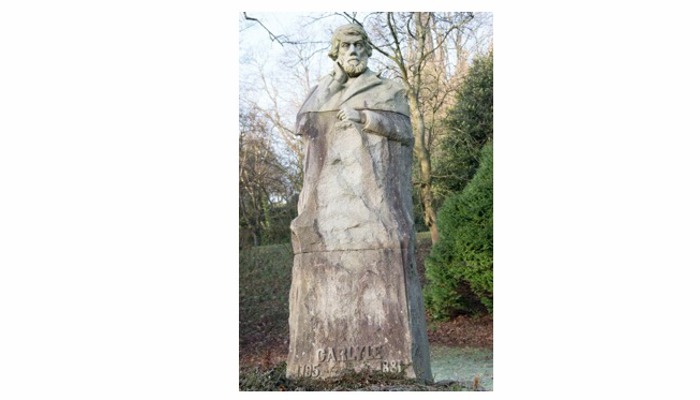 a statue of a figure in robes looking straight ahead.