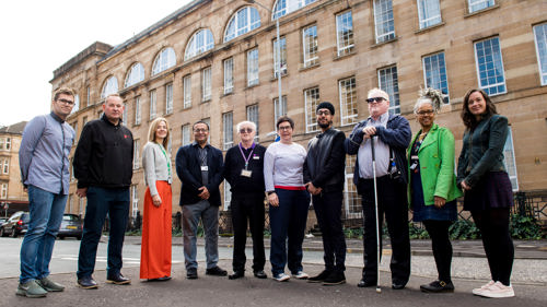 Ten Glasgow Life staff members standing outside in a semi circle. The group represents a mix of genders and ages.