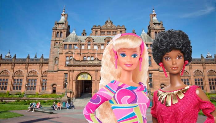 two Barbie dolls side by side in front of Kelvingrove Art Gallery and Museum a large ornate red sandstone building