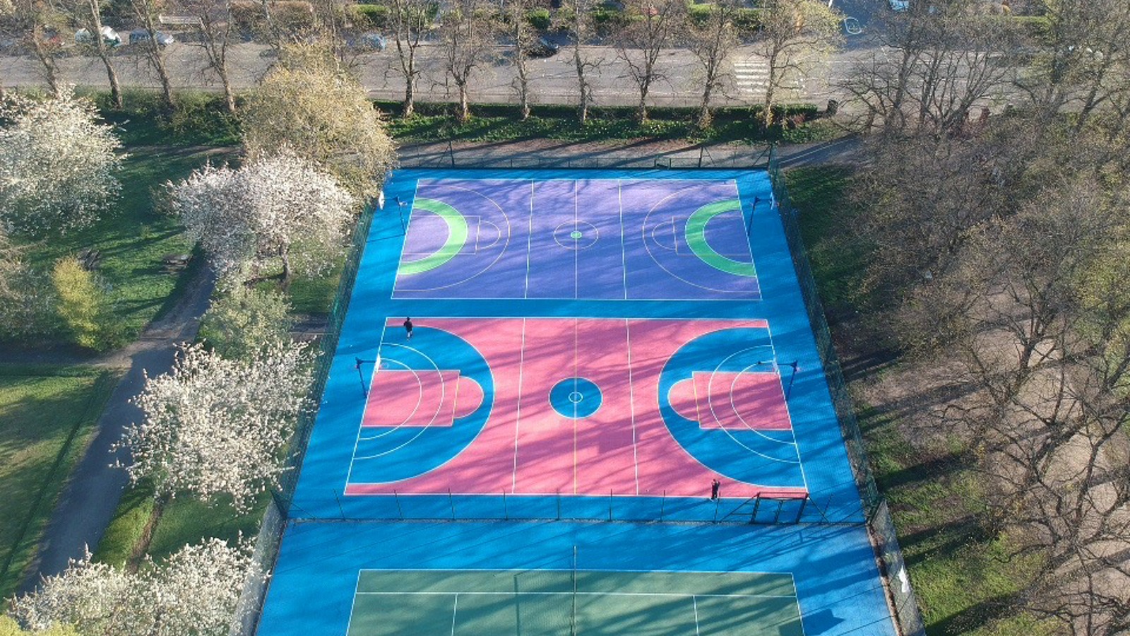 Multicoloured basketball and netballs painted blue, pink, purple and green