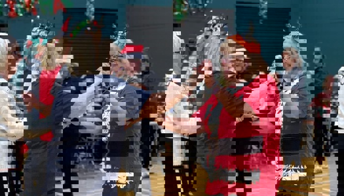 Groups of people taking part in a Christmas-themed dance class