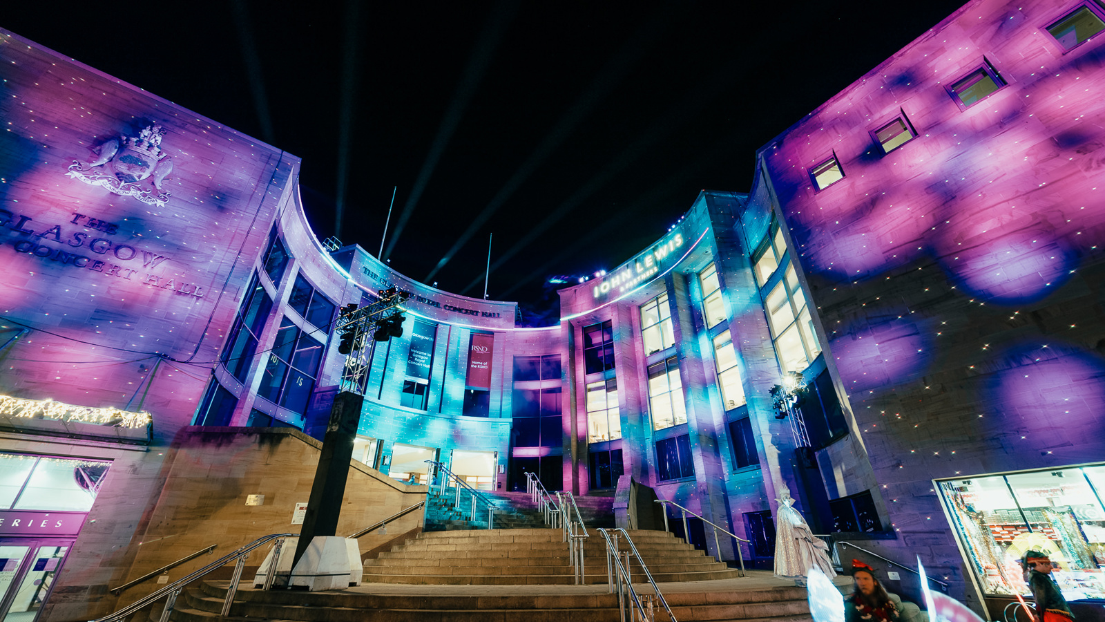 Colourful festive lights projected onto a city centre concert hall