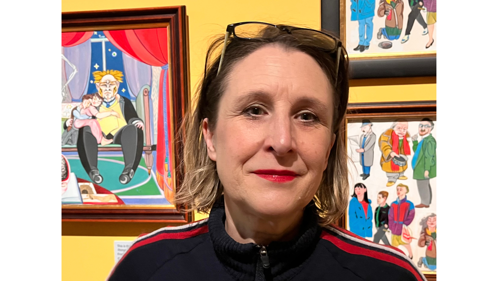 woman in front of 3 brightly coloured paintings in a gallery setting