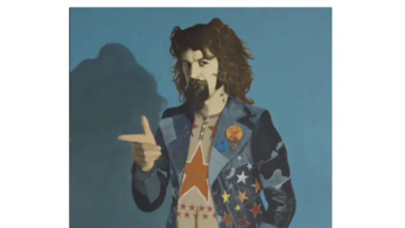 Painted full-length portrait of Sir Billy Connolly by artist John Byrne. Billy is in a star-decorated patchwork denim outfit and platform shoes, standing against a blue background and making a finger-pointing gesture.