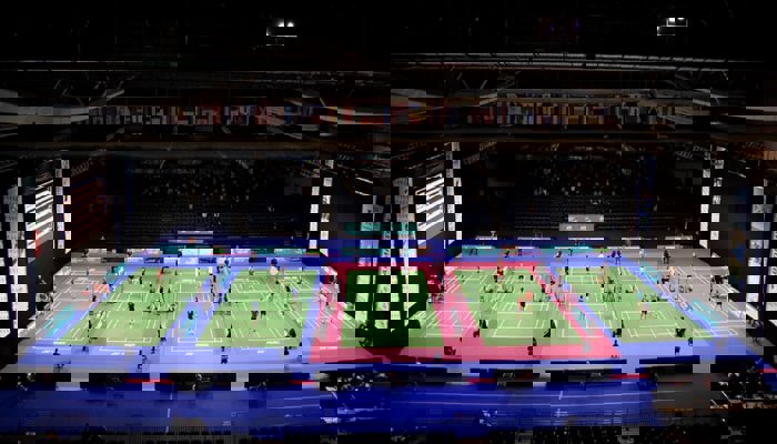 An aerial shot of five badminton courts with competitors playing on the during the Scottish Open Badminton.
