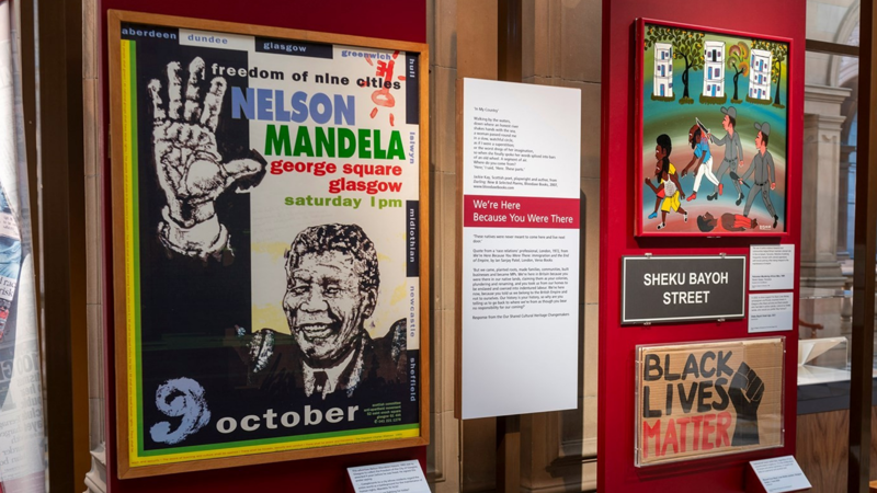 Exhibition display at Kelvingrove Art Gallery and Museum featuring posters, artwork and interpretive panels exploring Black history, activism and cultural heritage.