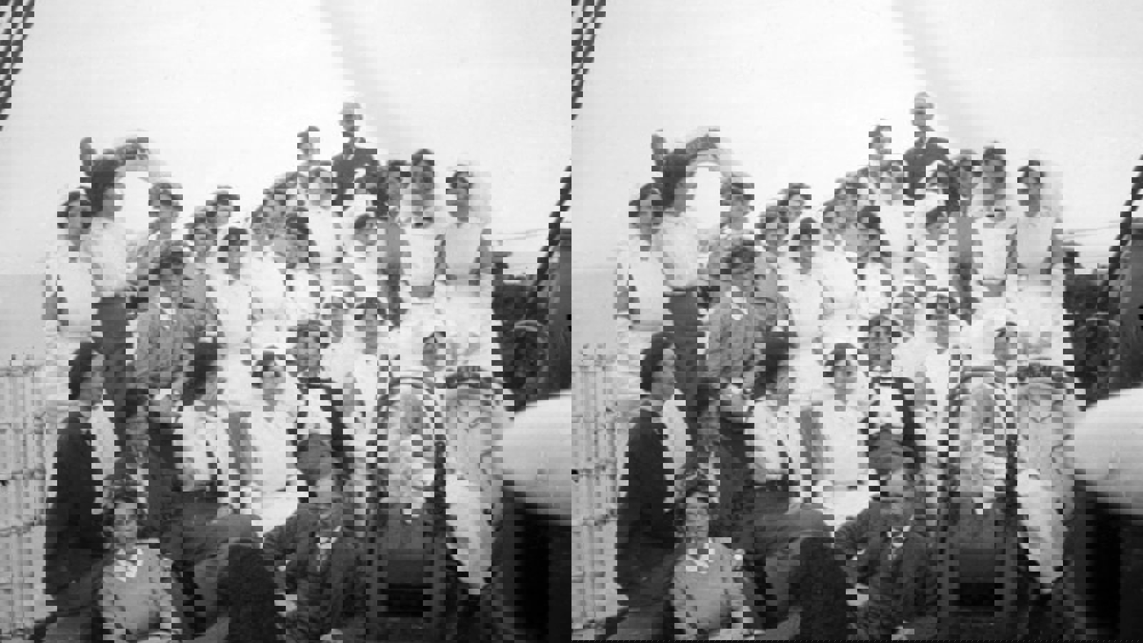 A black and white photograph of a group of people from the Scottish Women's Hospital on a ship wearing white uniforms and dark suits.