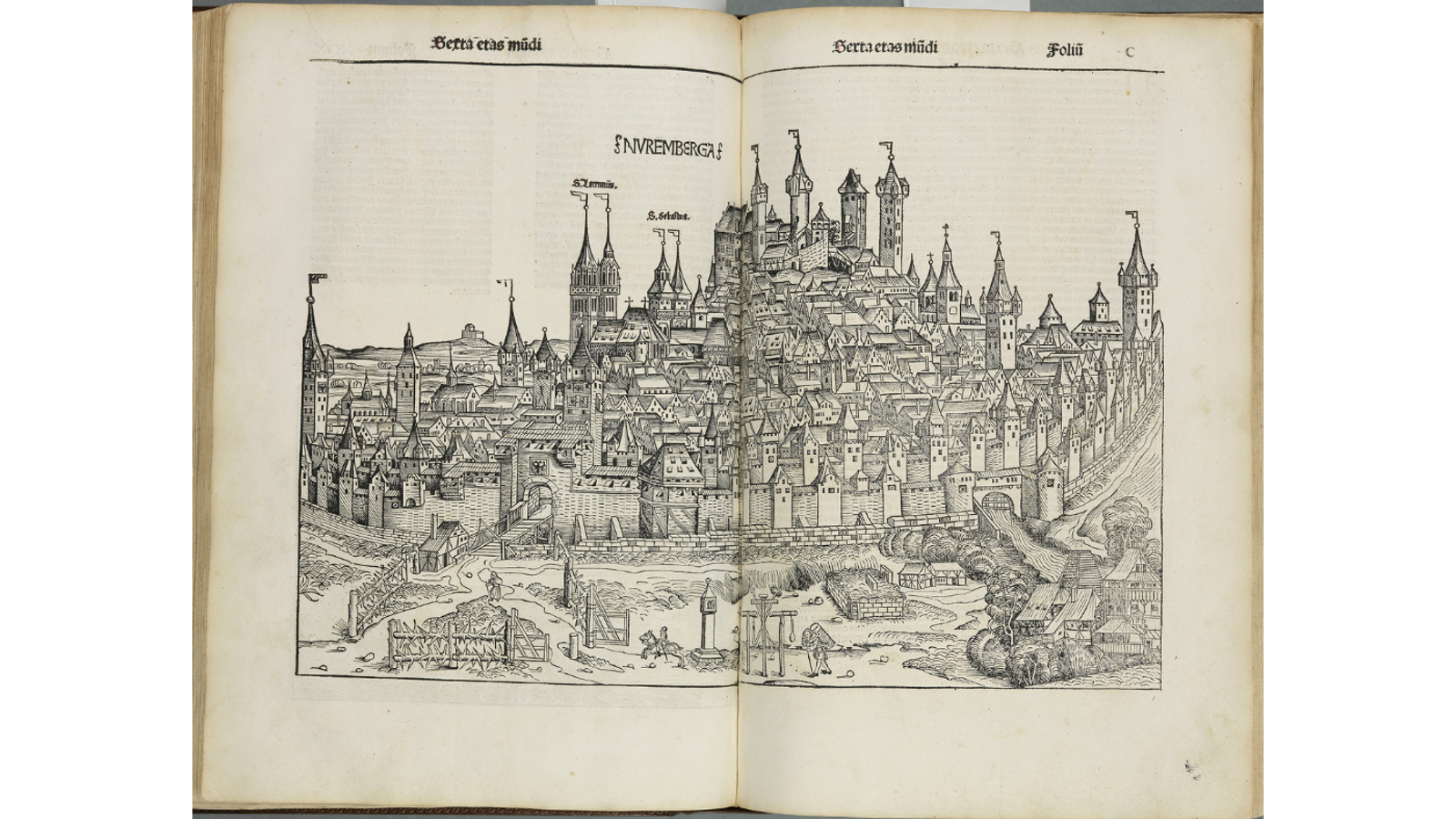 An open two-page spread of an early printed Latin book featuring a double-page woodcut illustration depicting a detailed cityscape of Nuremberg.