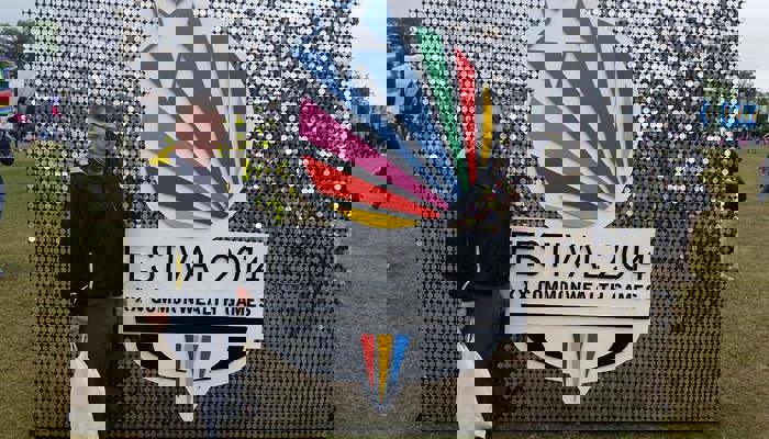 Andrew McVie in front of the shiny Festival 2014 sign at Glasgow Green during the Commonwealth Games.