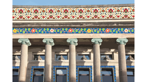 A collage image of a classical facade of a building. There are Persian patterns collaged between the stones