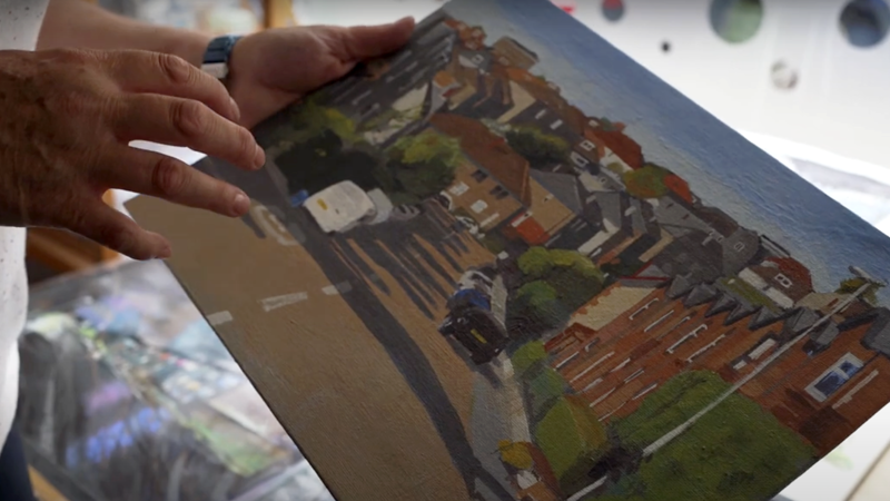 Fiona shows a painting of the local area.