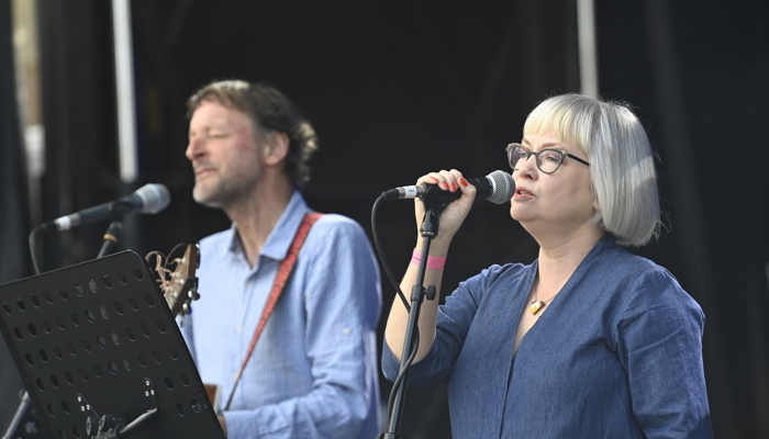 Two people sing on stage as part of UCI festivities. 