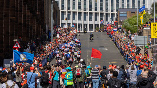 Professional cyclists racing up a hill on Montrose Street in Glasgow
