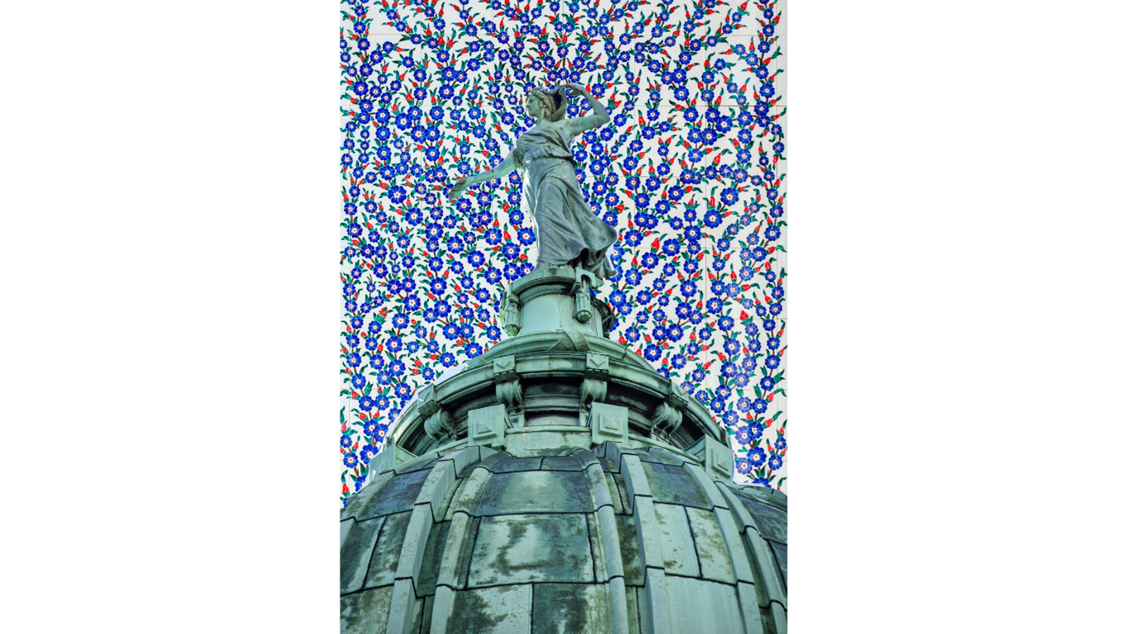 Copper sculpture of a women, collaged against a background of Persian flower patterns