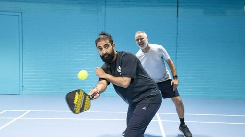 2 people playing Pickleball