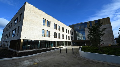 Exterior of a modern three storey community building on a clear day