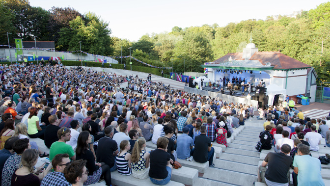 Crowds sitting down watching a performance at the Kelvingrove Bandstand during the Glasgow 2014 Commonwealth Games.