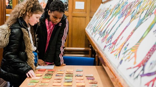 Two young people look at the Gaelic alphabet, which is part of a larger exhibition 