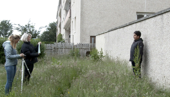 A young teenager is being filmed.