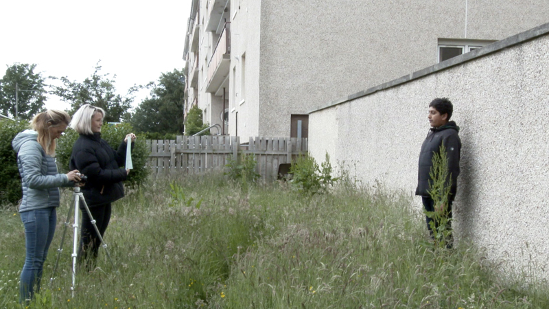 A young teenager is being filmed.