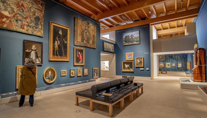 Central galleries of Burrell Collection, showing paintings framed on tall blue walls