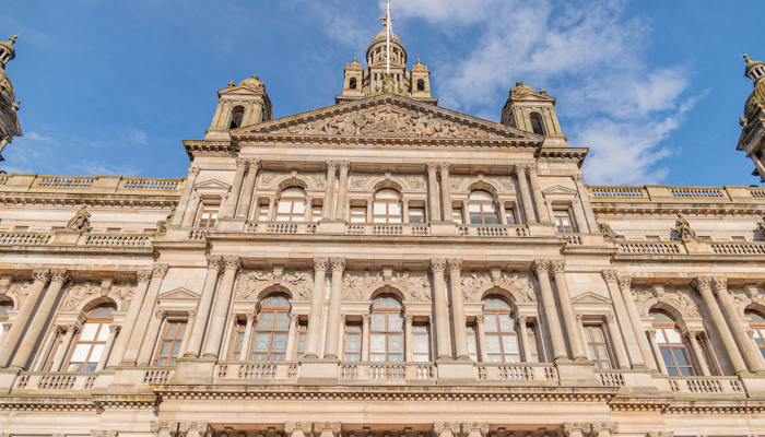 The front of an 1800s building beneath a blue sky